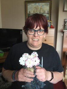 Kirsty at home with the flowers she made in her Zoom craft class